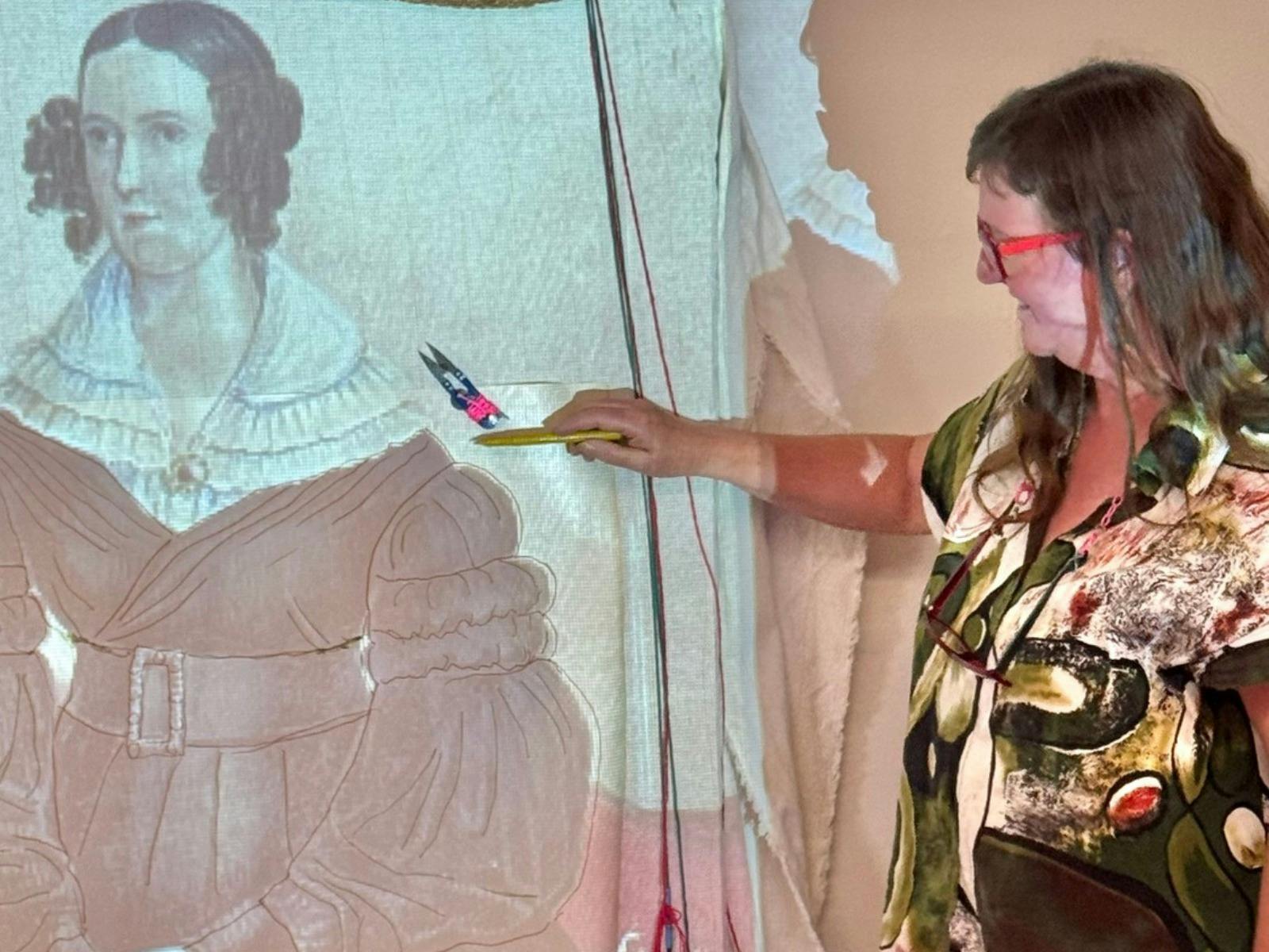 Artist refers to a historic image of a woman's sleeve and is tracing it