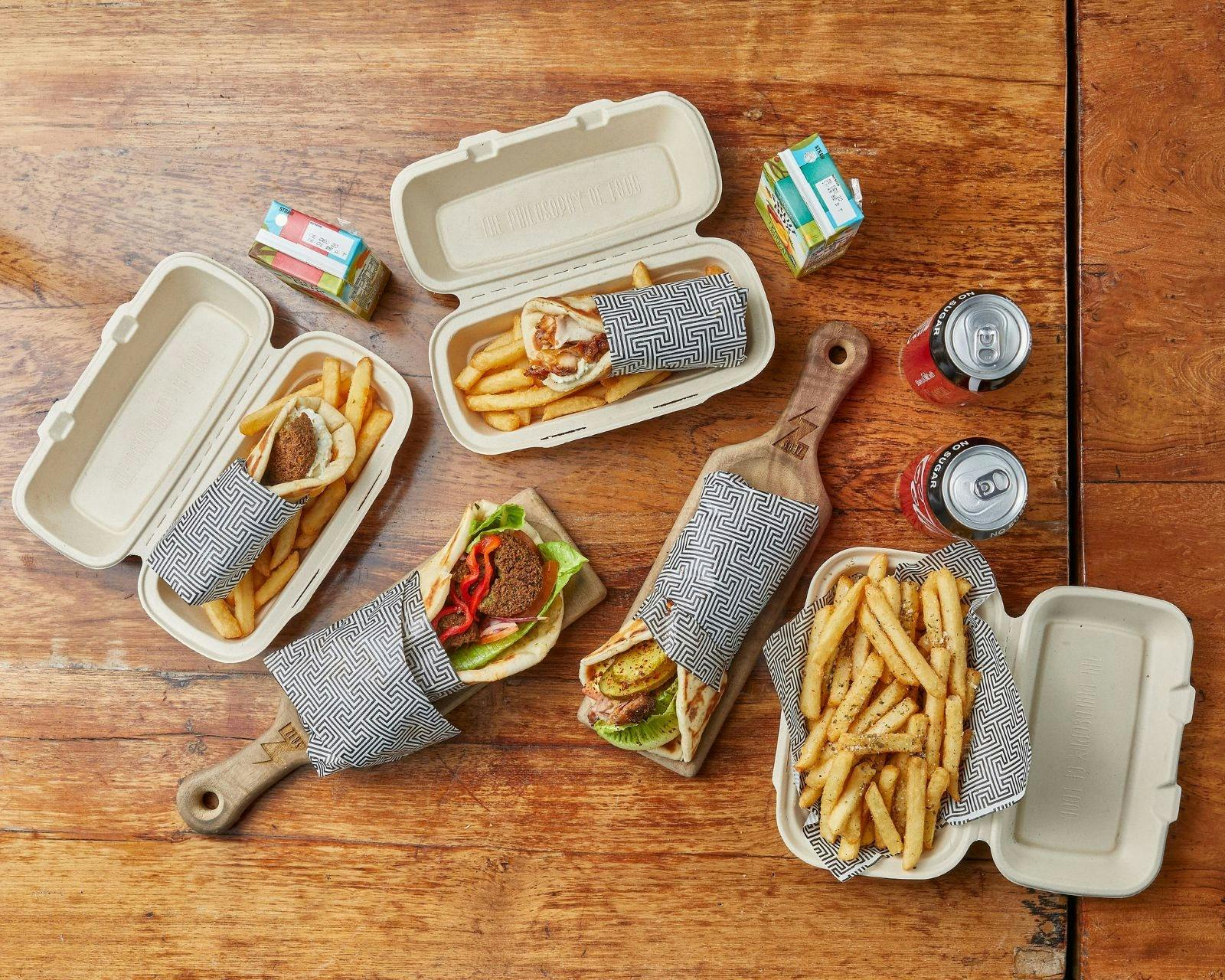 An array of dishing including hot chips & Pita Wraps at Zues Street Greek Restaurant Shellharbour