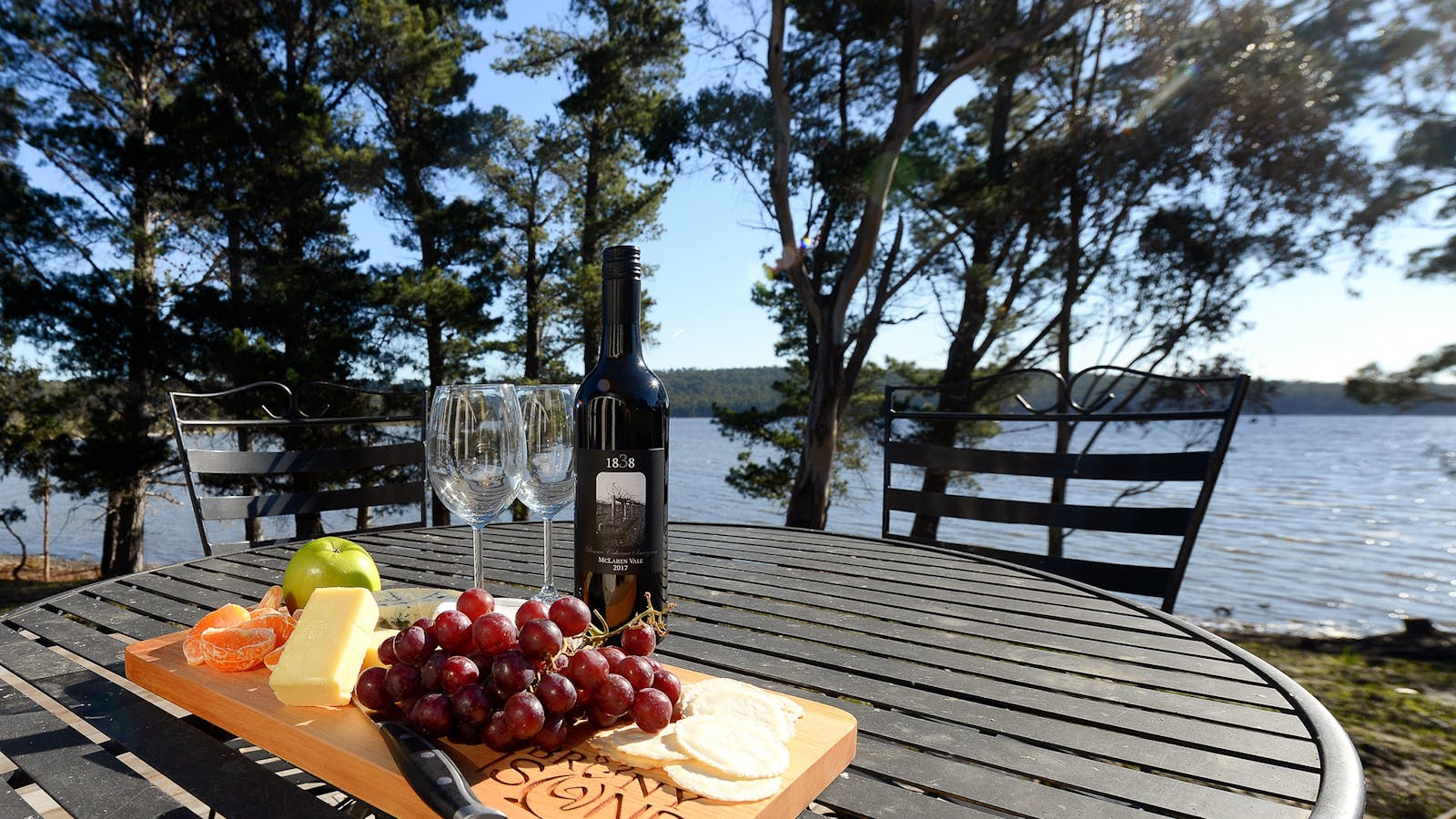 Taylors Bay Cottage: wine and cheese platter upon table on the deck.