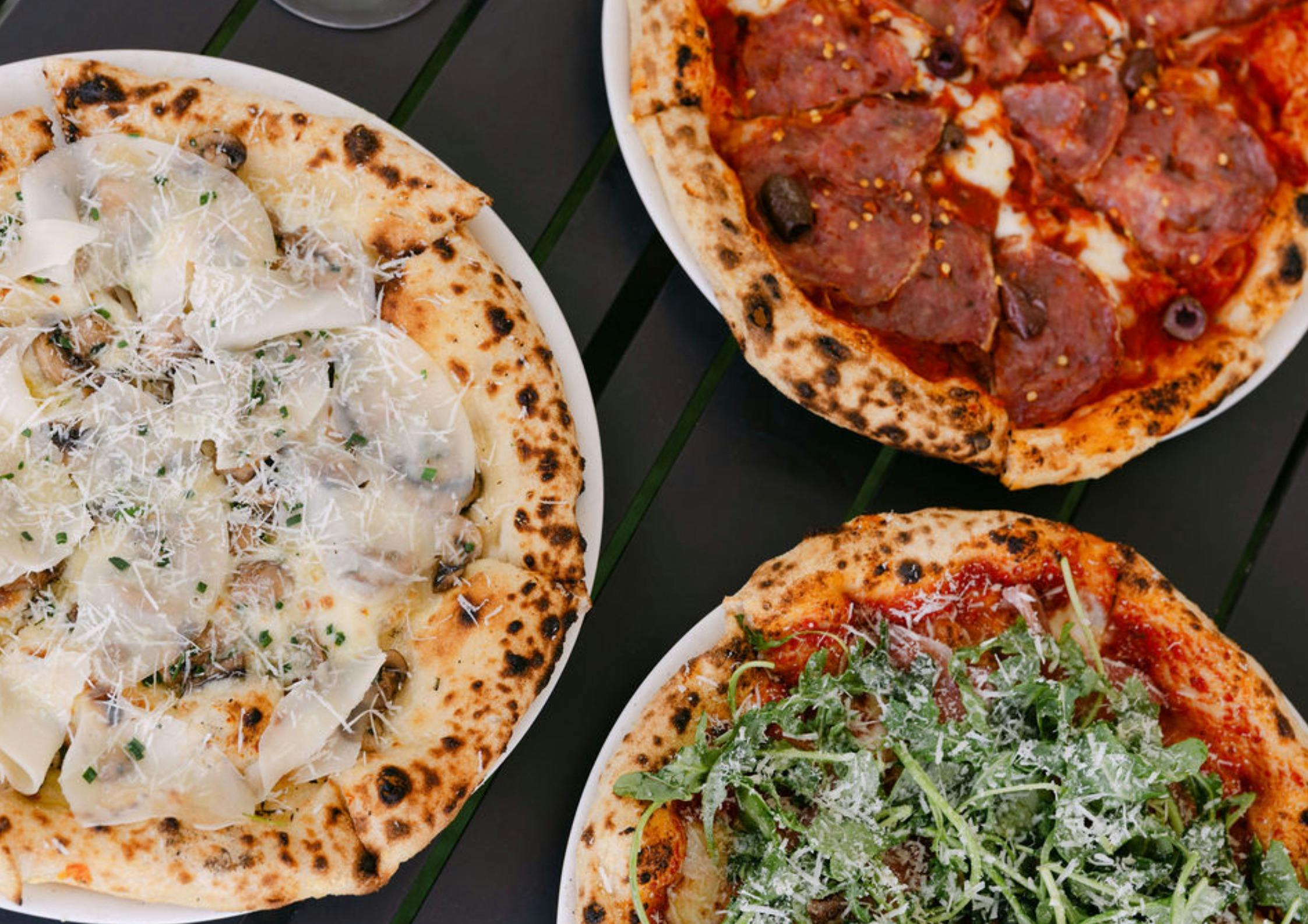 3 woodfire pizzas with different toppings, cheese, salami, mushroom, rocket