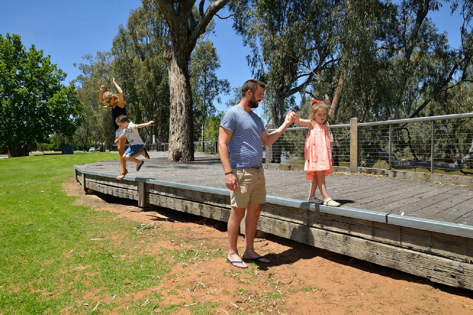 Family playing on boardwalk