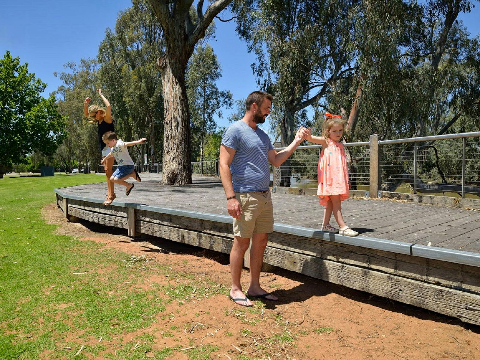 Family playing on boardwalk