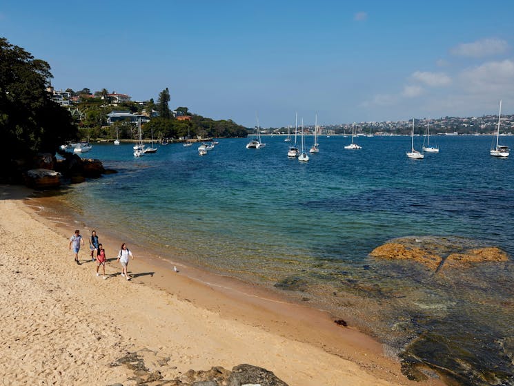 Friends enjoying a walk along Milk Beach on the Hermitage Foreshore Track, Vaucluse in Sydney
