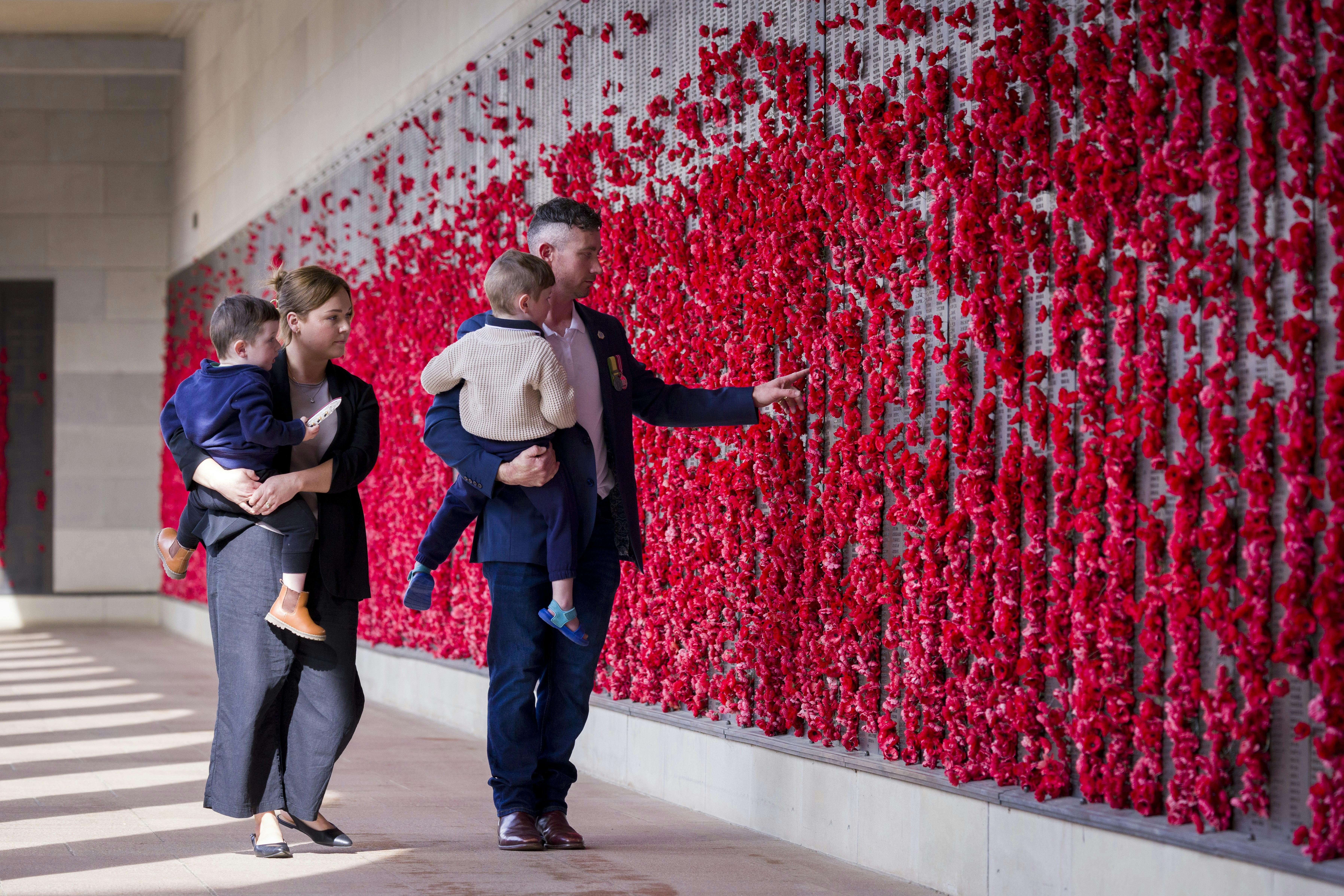 Family visiting the Australian War Memorial and walking through the Roll of Honour