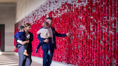 Family visiting the Australian War Memorial and walking through the Roll of Honour