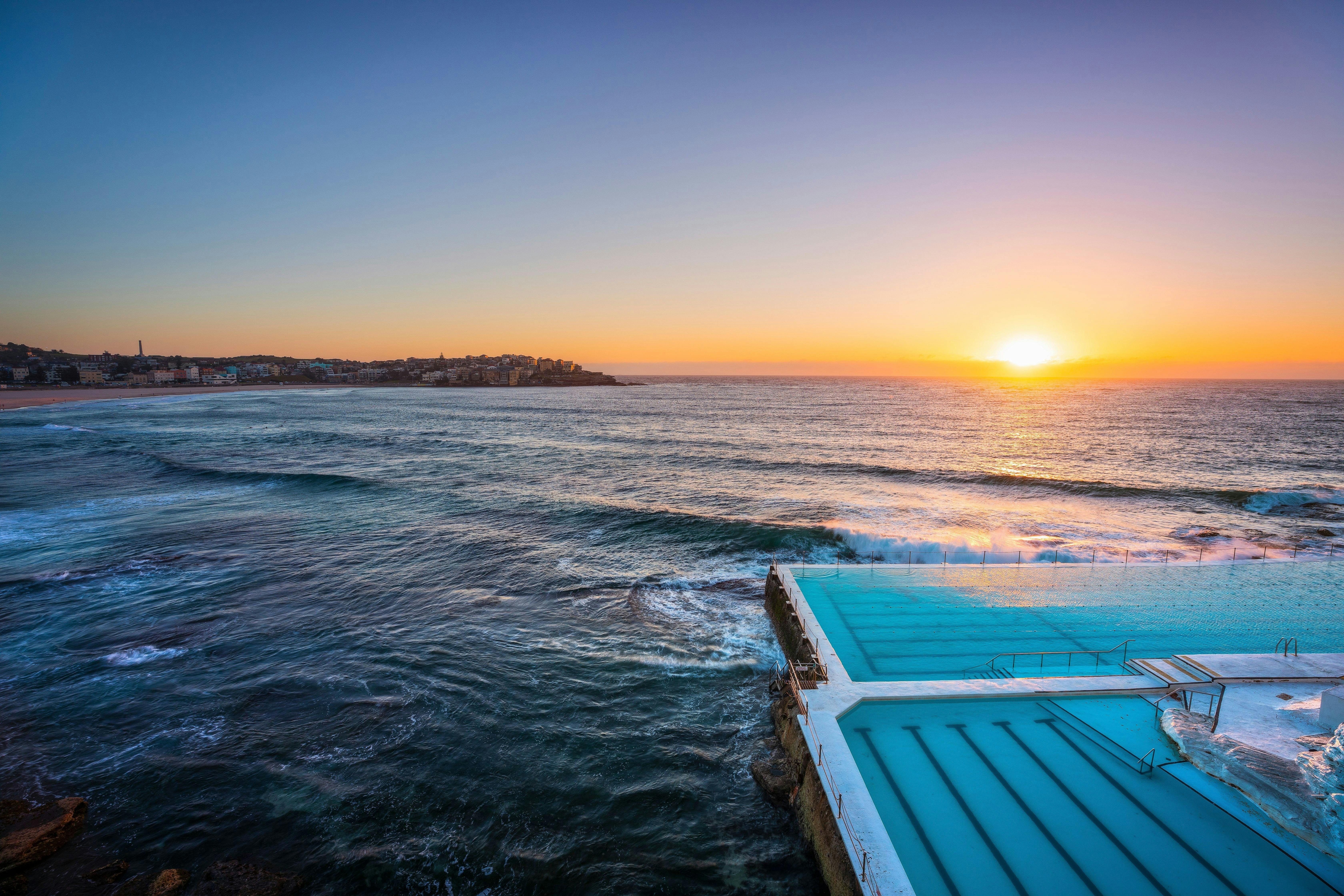 Morning sun rising over Bondi Icebergs, Bondi Beach