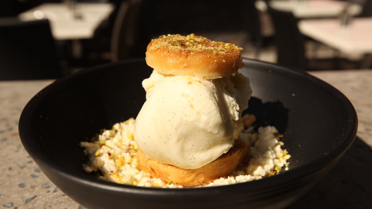 Baklava & vanilla bean ice cream sandwich served on soft white cheese drizzled with rosewater