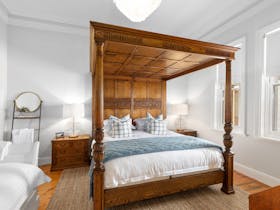 A solid oak four-post King size bed and additional single bed in this North-facing room with a view