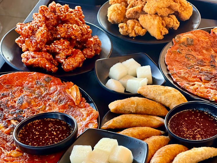 Traditional dishes served at Jiggle, including dumplings, pancakes and Korean Fried Chicken.