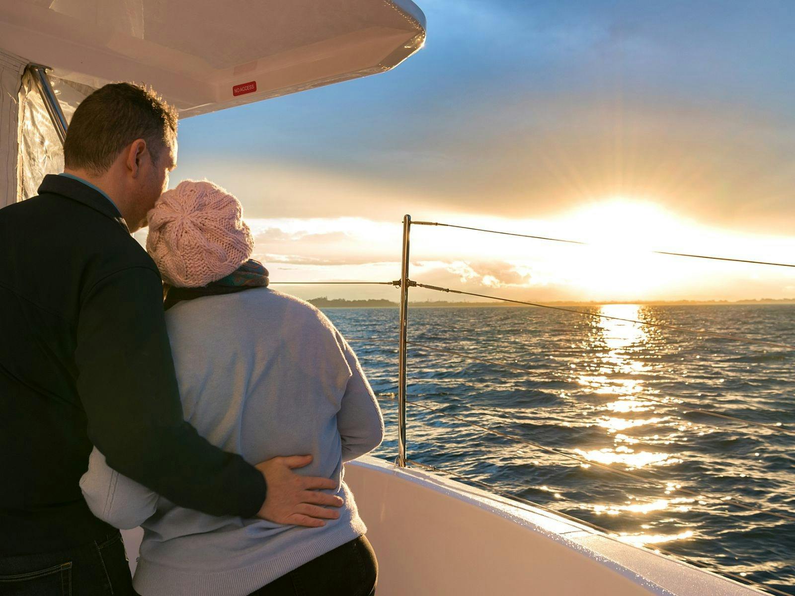 See the sun set over the water.