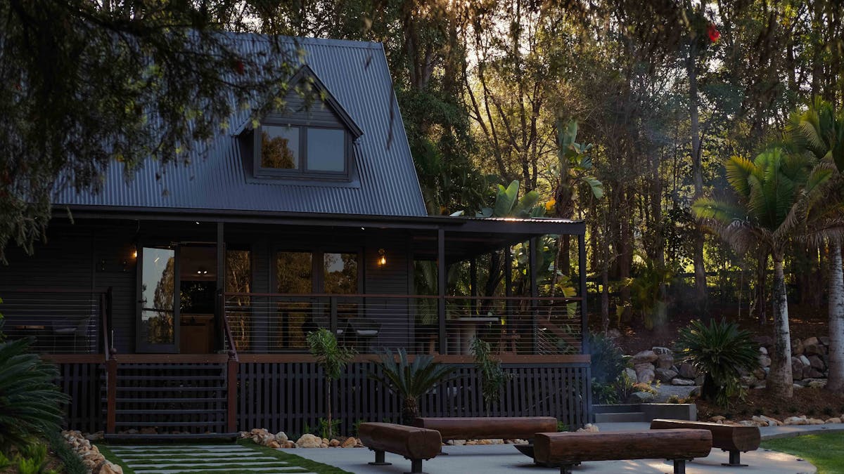 Main house with deck, outdoor dining table and fire pit