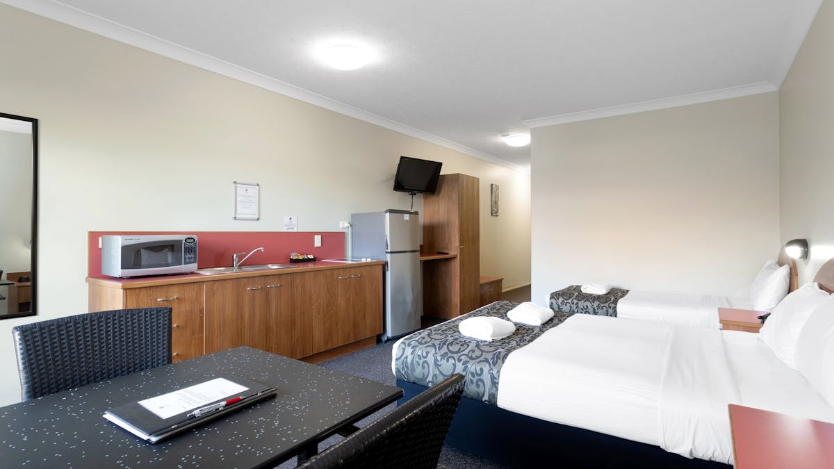 Twin Self-Contained Unit features a kitchenette and furnished balcony.
