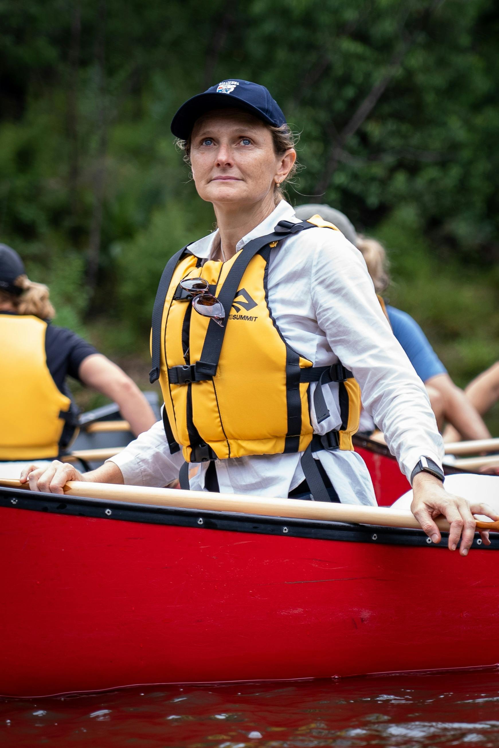 woman in a red canoe looking into the distance