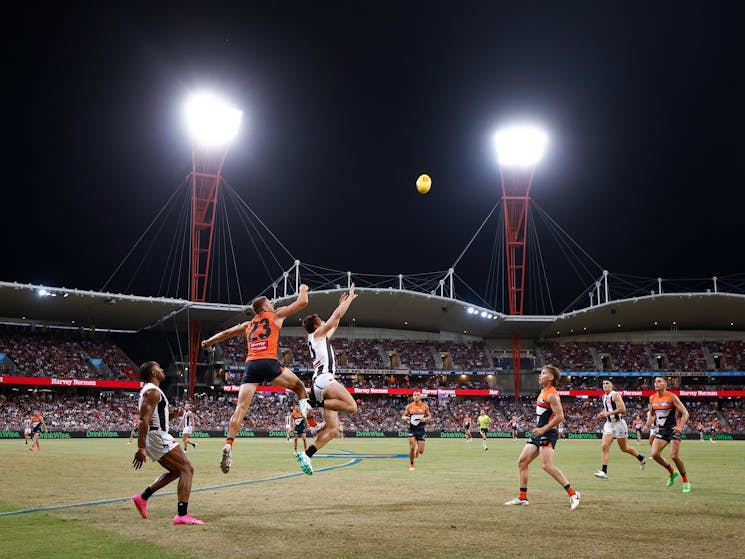 Jesse Hogan of the GWS GIANTS looks to spoil Collingwood's Charlie Dean as he attempts to mark.