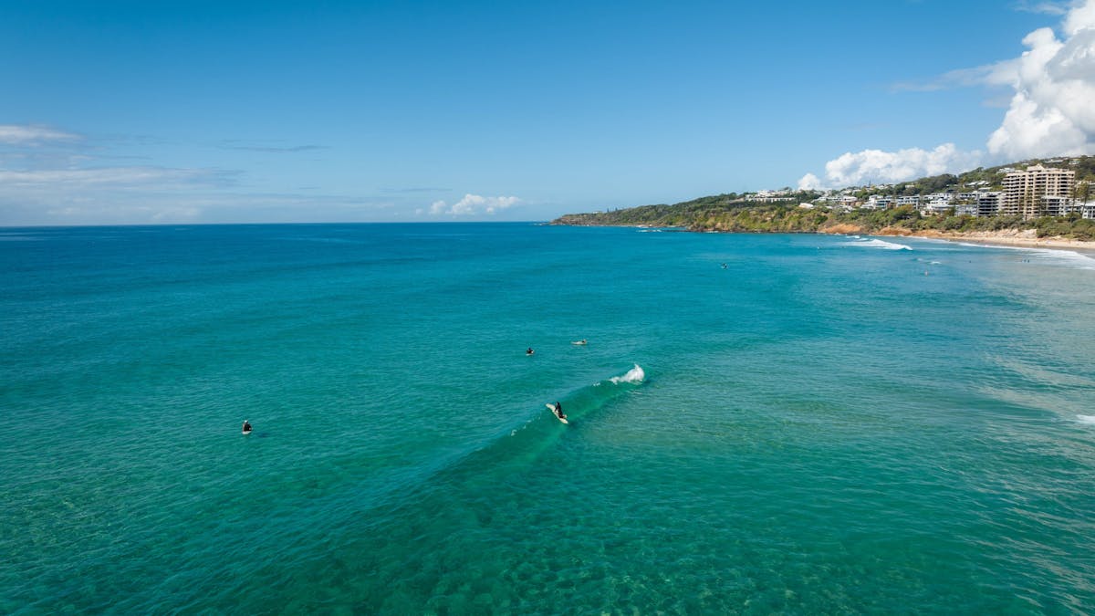 Arial view of Coolum Beach. Ocean view with surfers in the water.