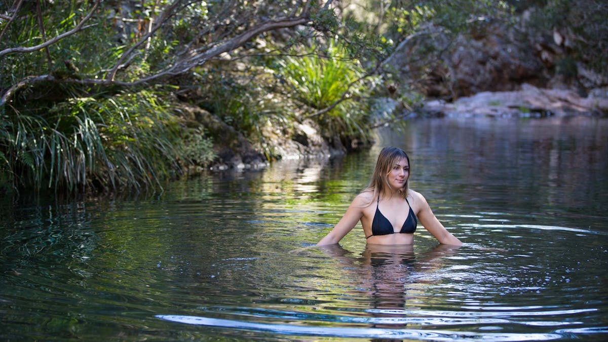 Woman having a swim in Rocky Hole, which is located in Mount Mee Forest Reserve