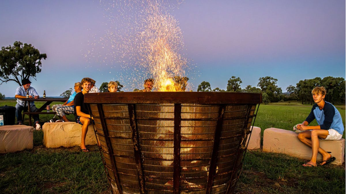 an image of family around fire pit