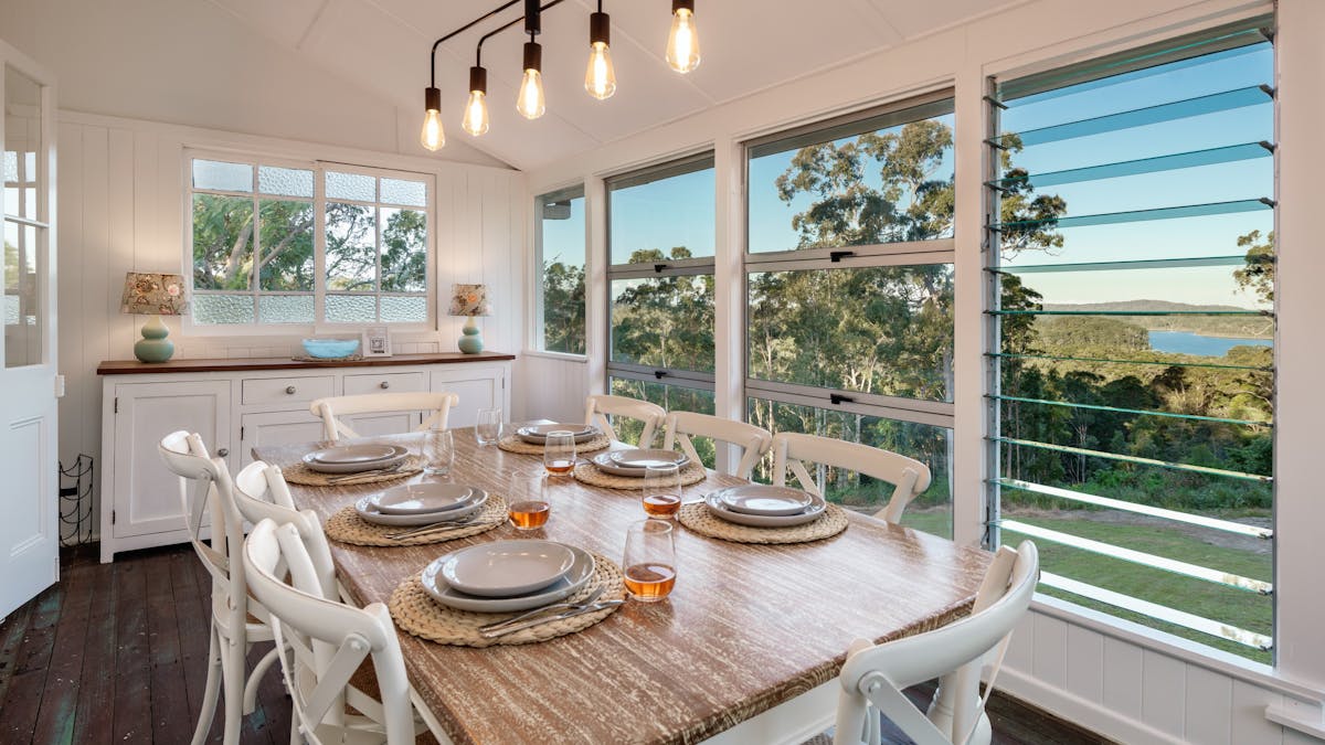 The charming dining room with stunning views of the Dam and bushlands.