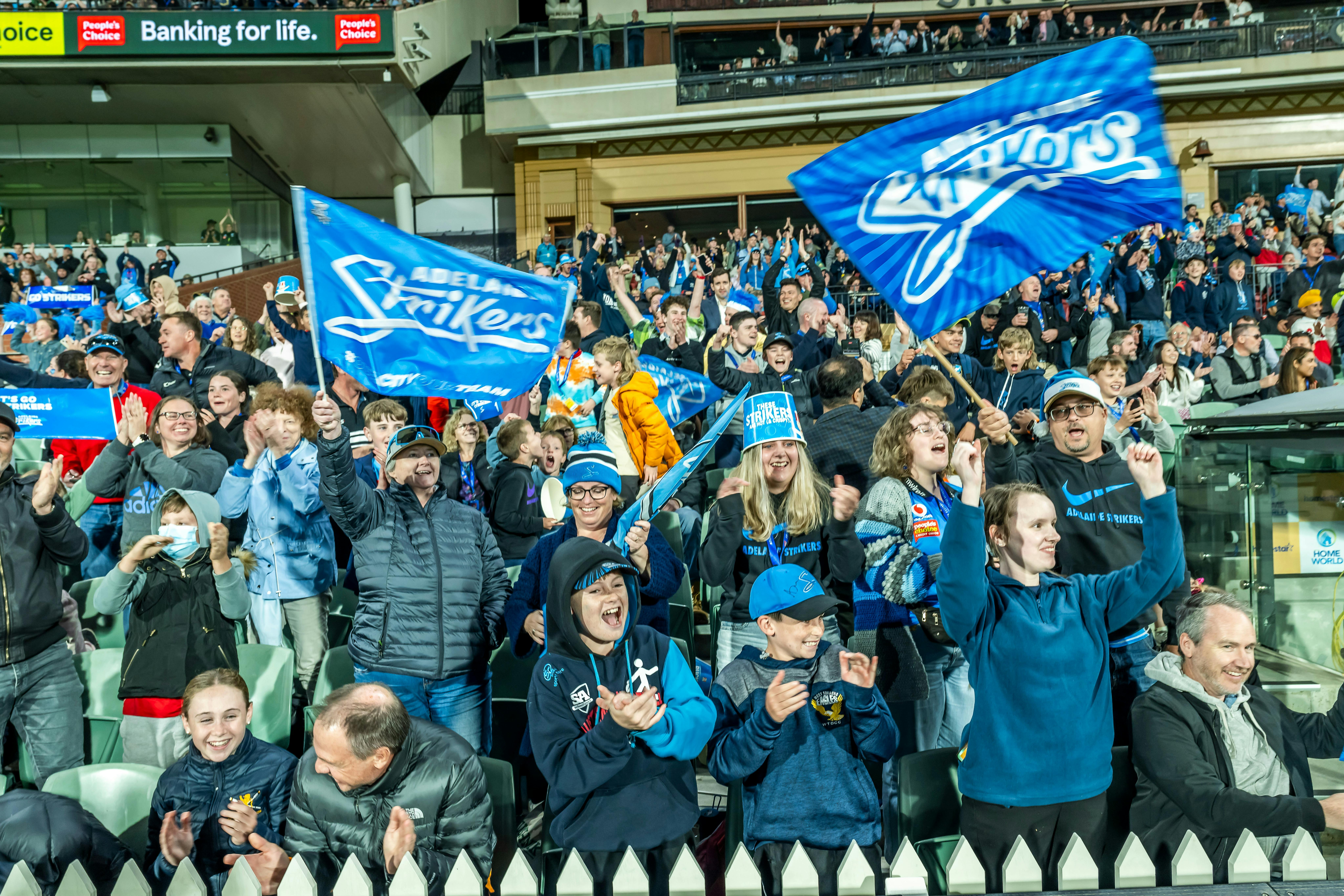 Fans cheering on the Adelaide Strikers at Adelaide Oval