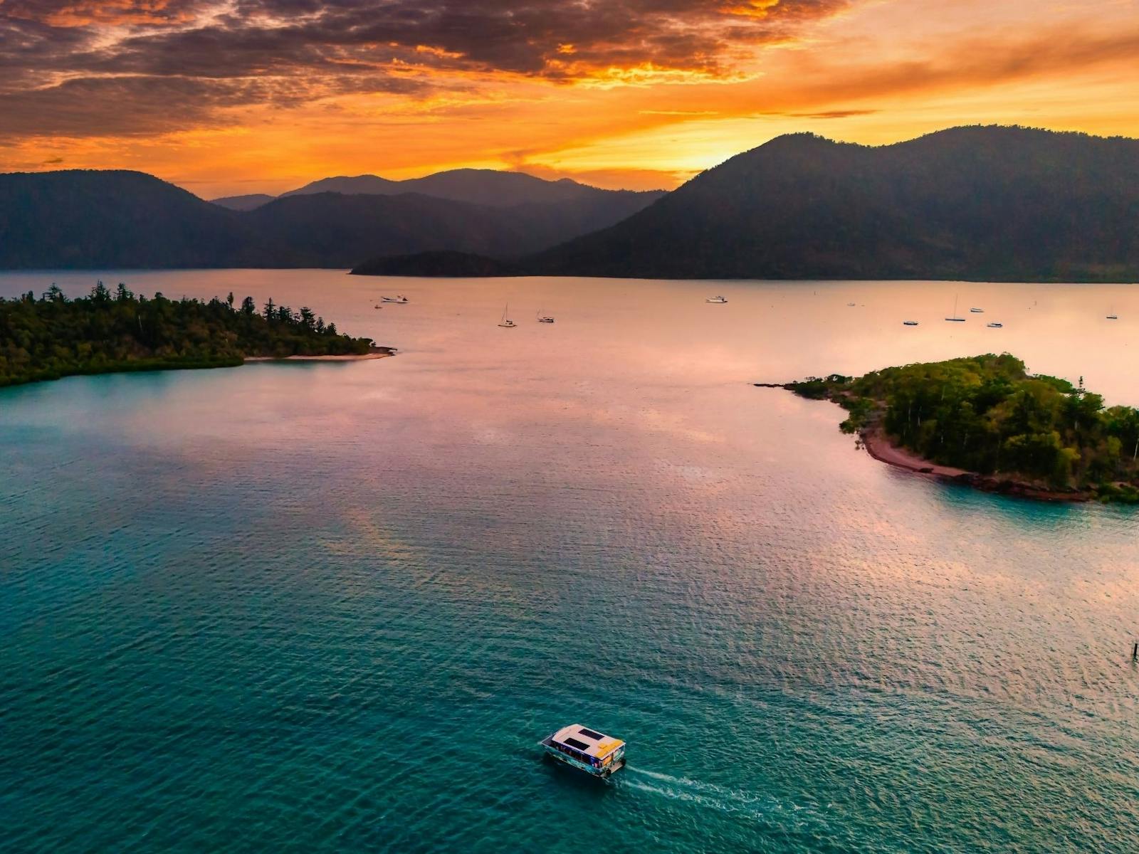Landscape view of glass bottom boat cruising in to sunset Landscape view of glass bottom boat cruising in to sunset
