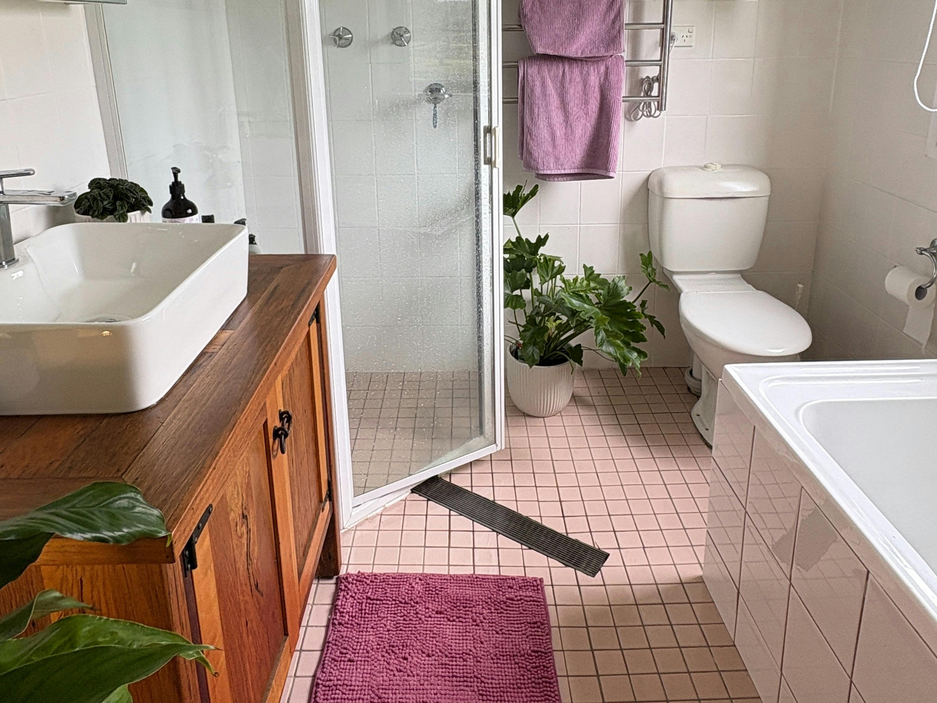 Rustic farm bathroom with timber and pink accent colours