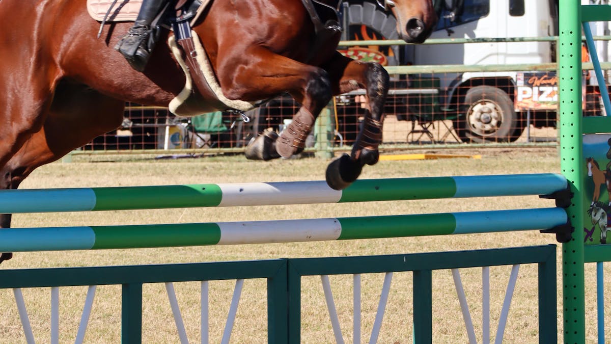 Girl on horse riding over a jump Girl on horse riding over a jump