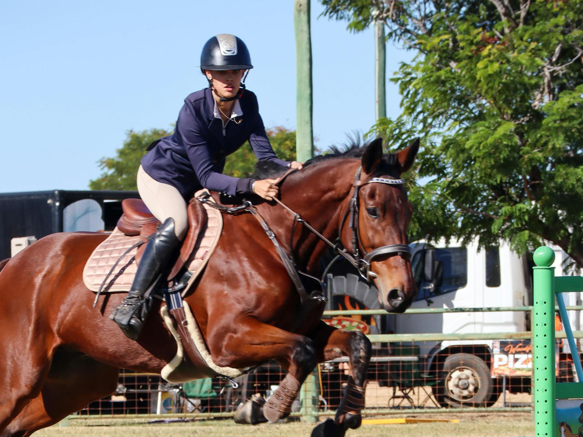 Girl on horse riding over a jump Girl on horse riding over a jump