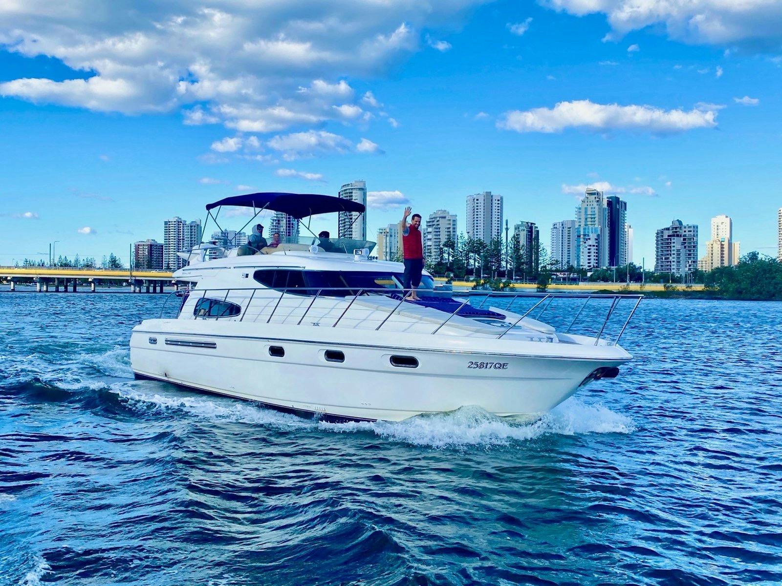 Luxury yacht on clear blue water with city skyline in the background – Broadwater, Gold Coast. Luxury yacht on clear blue water with city skyline in the background – Broadwater, Gold Coast.