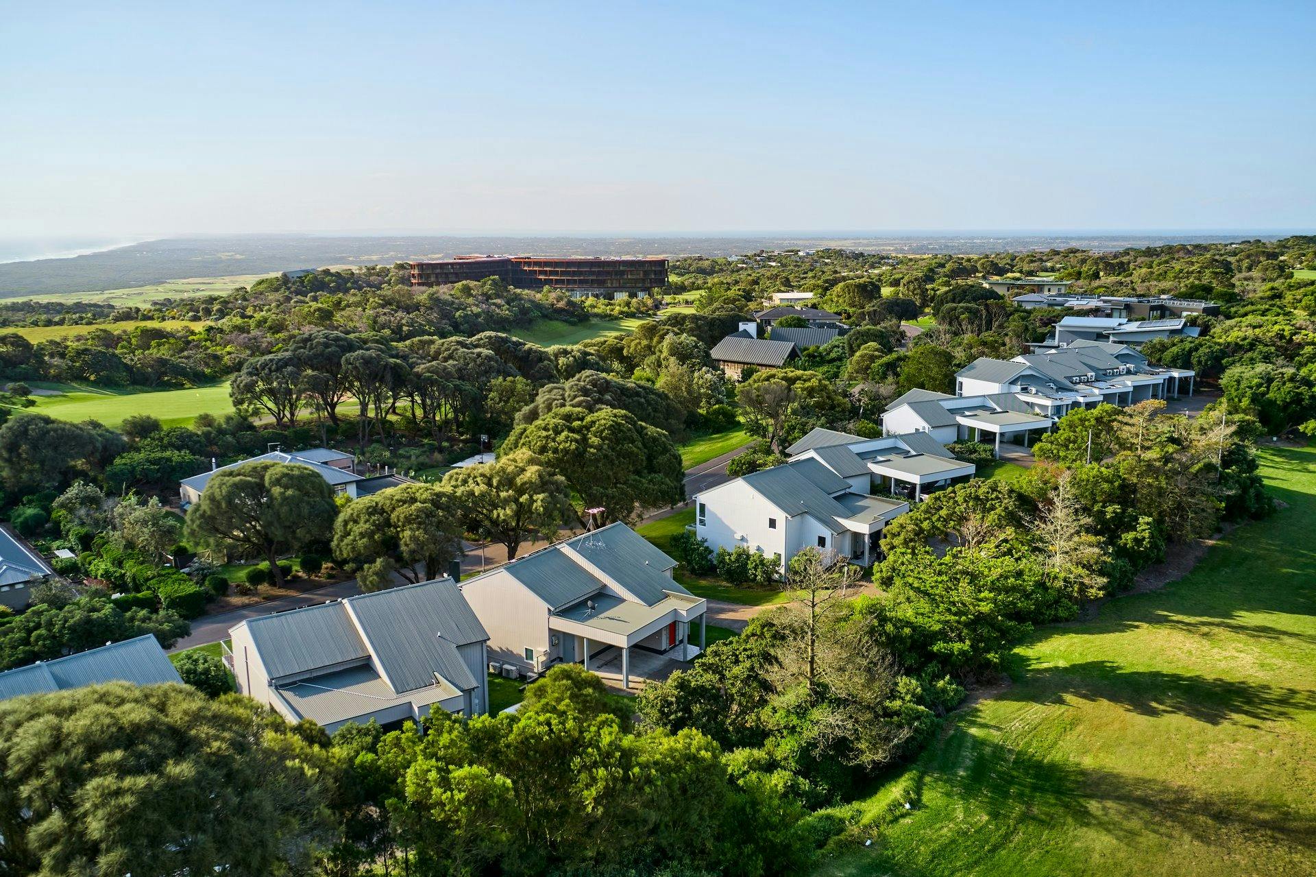 Drone shot of Golf Villas with the main building in the background.
