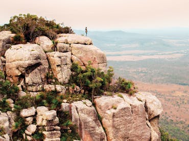 Man standing on summit of Mt Walsh. Man standing on summit of Mt Walsh.