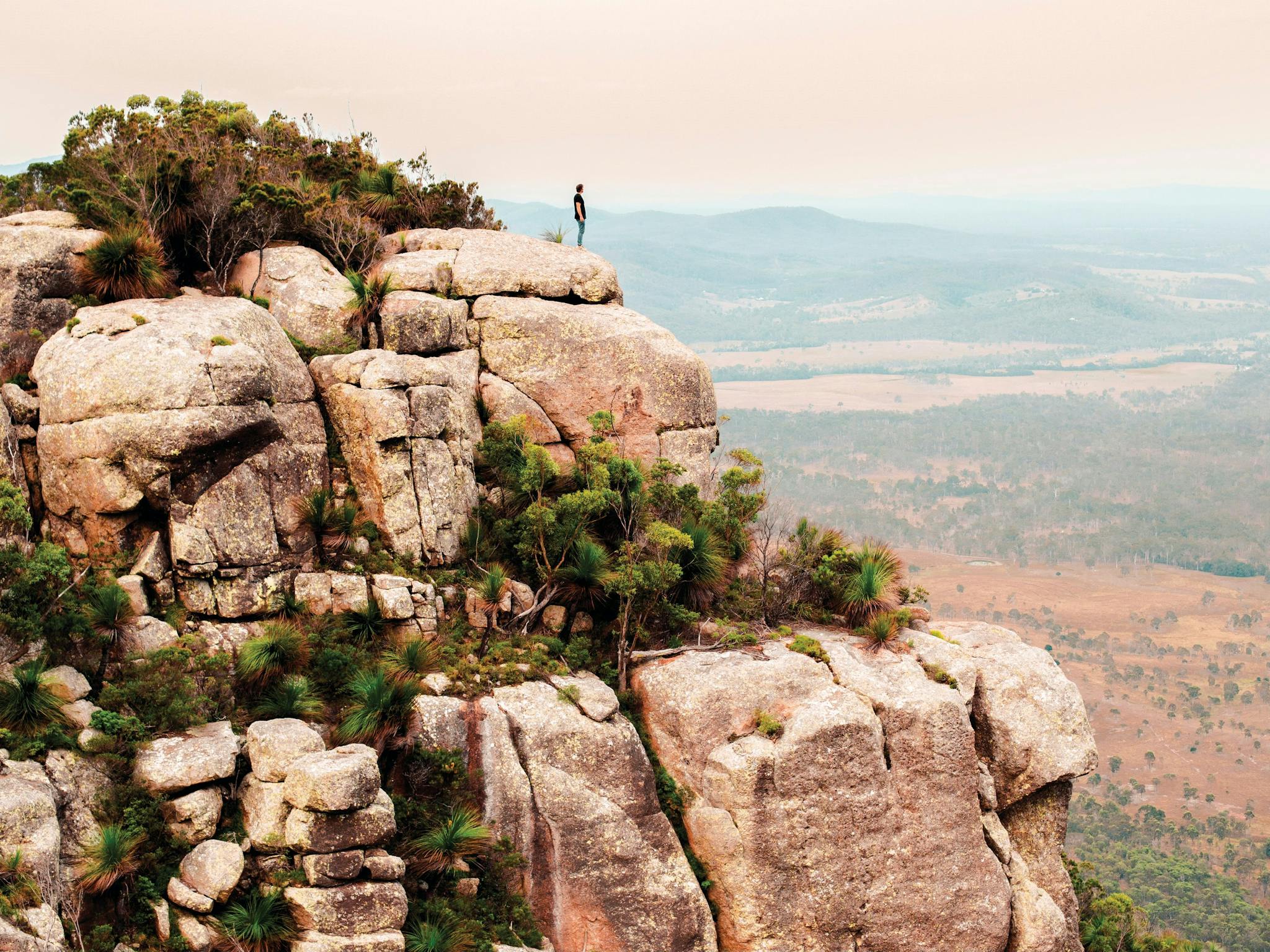 Man standing on summit of Mt Walsh. Man standing on summit of Mt Walsh.