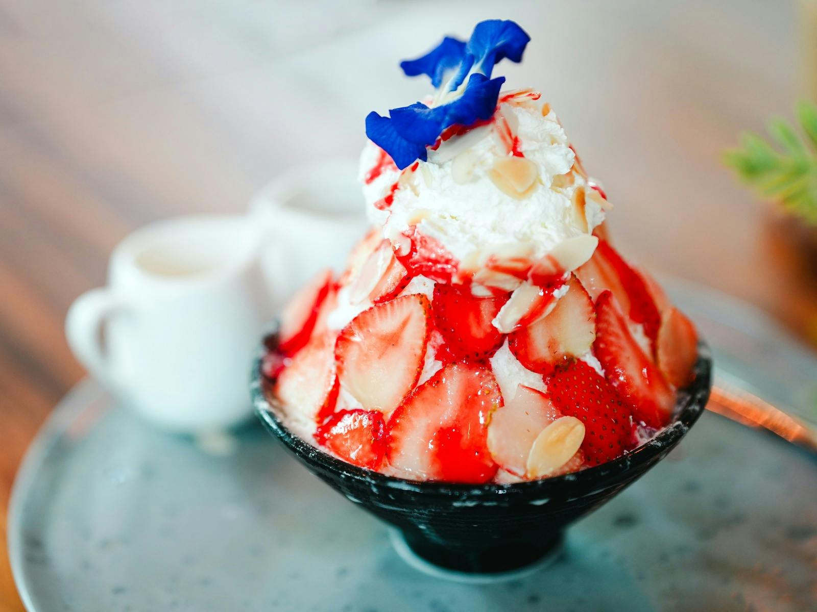 A decadent bowl of icy, creamy, strawberry goodness, finished with a flower on top!