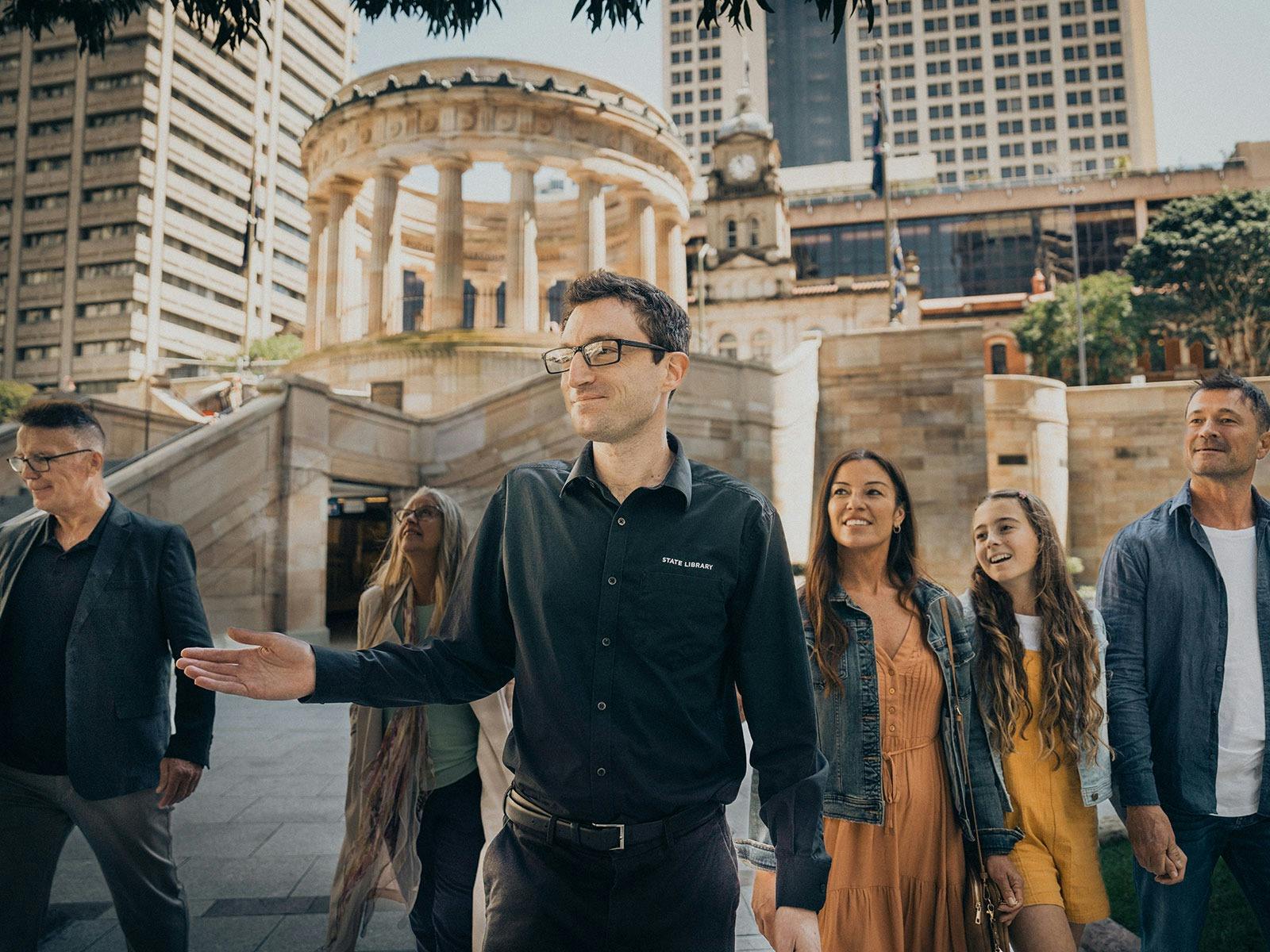 Visitors outside in the parklands on a guided tour of Anzac Square