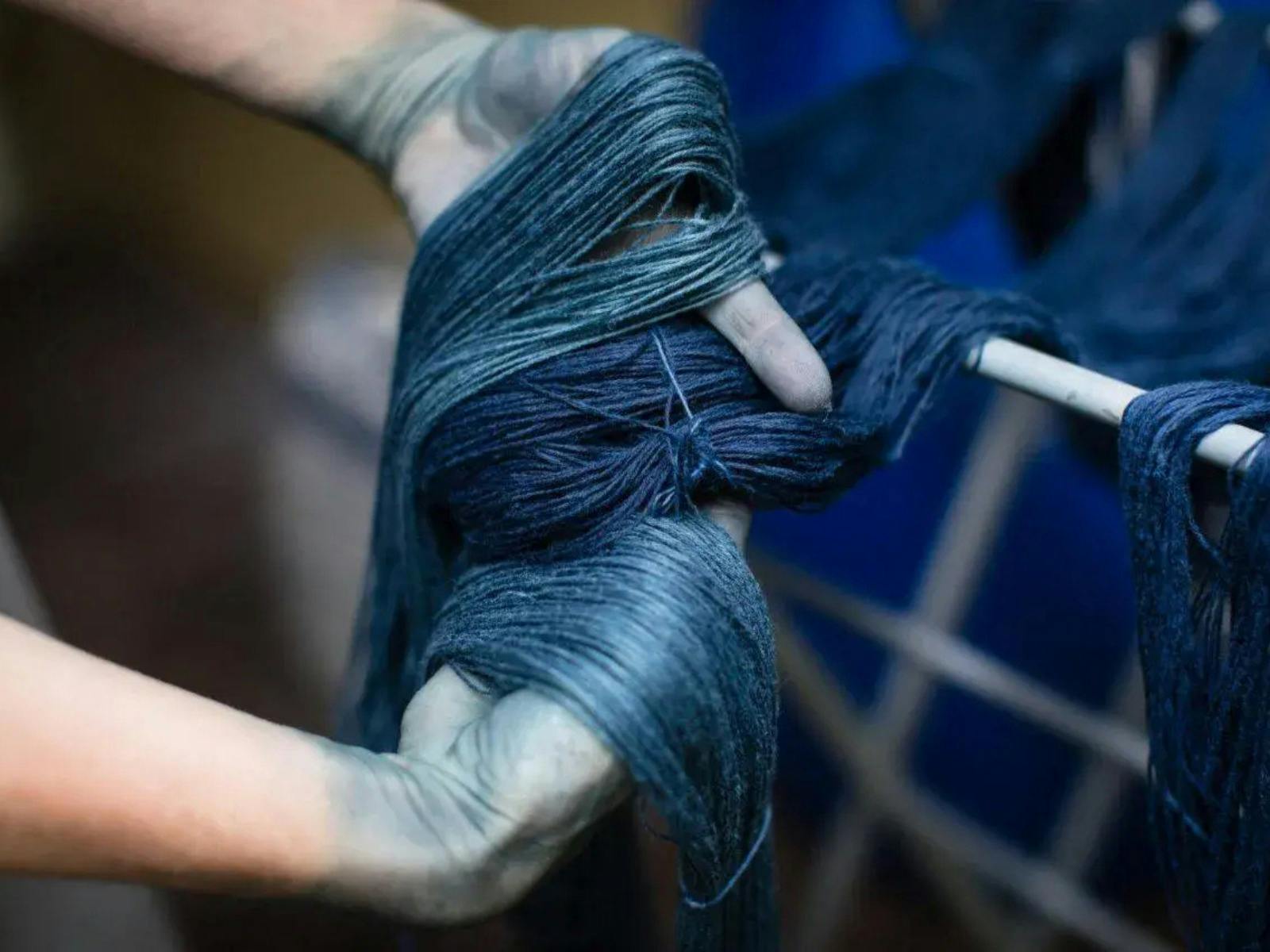 Pair of hands holding indigo dyed yarn
