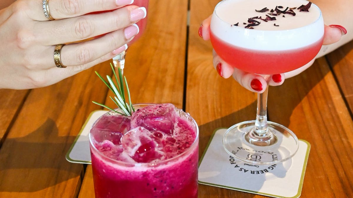 several pink cocktails on a table