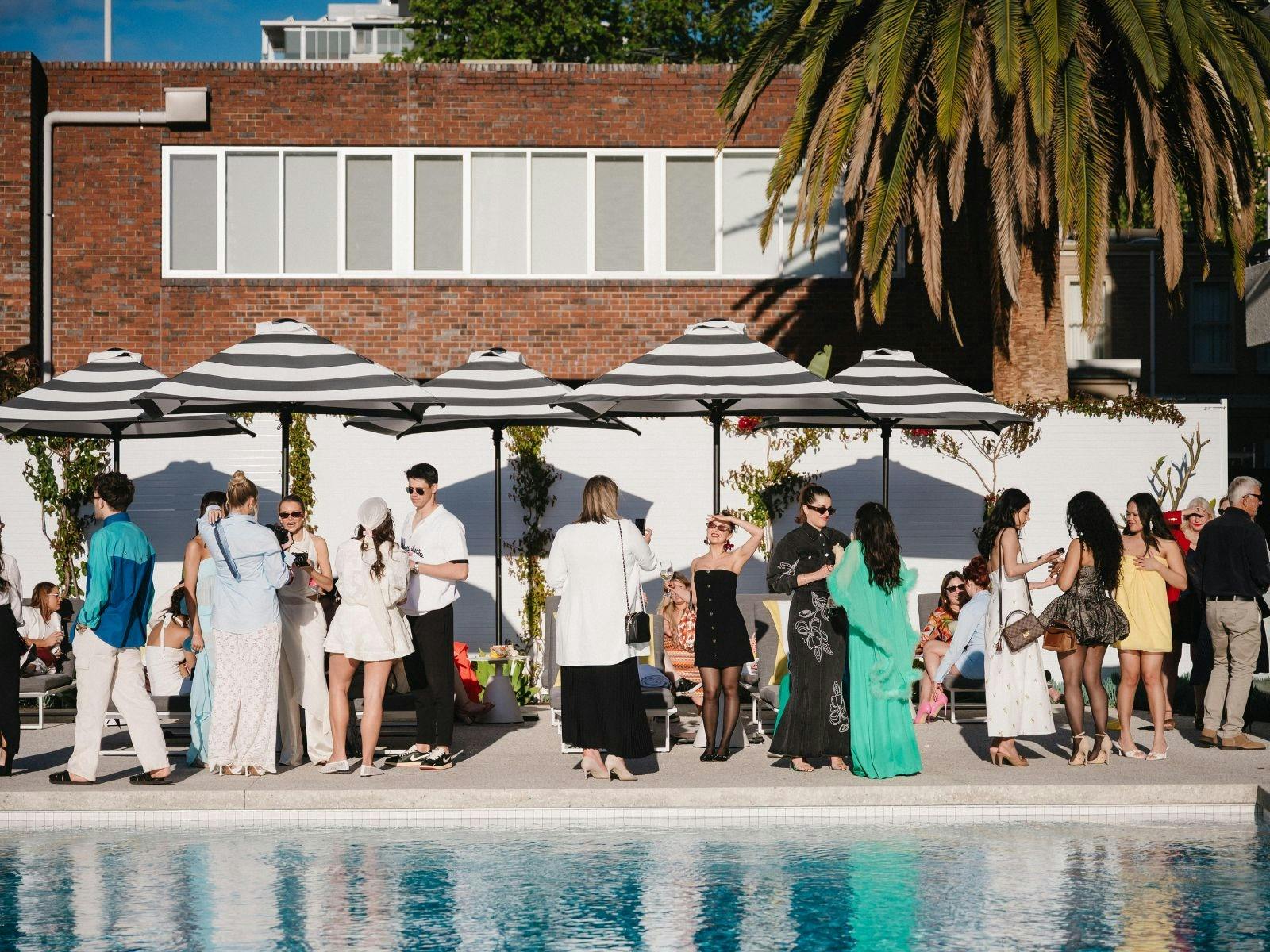 People standing by a pool at an event