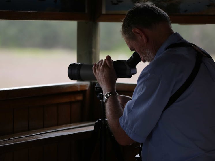 Person looking through binocular bird watching.