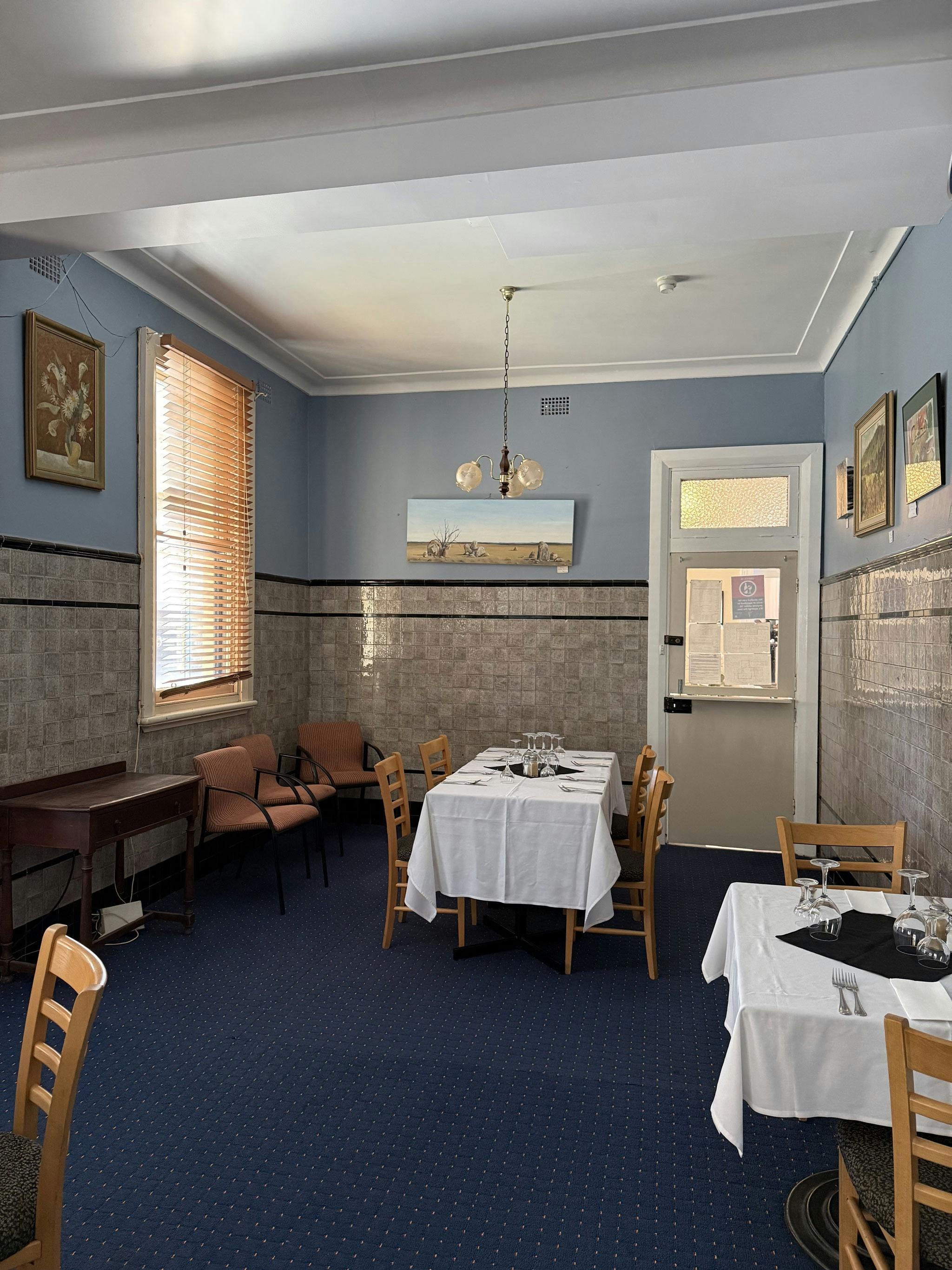 Heritage dining room with set tables at The Old Vic Canowindra
