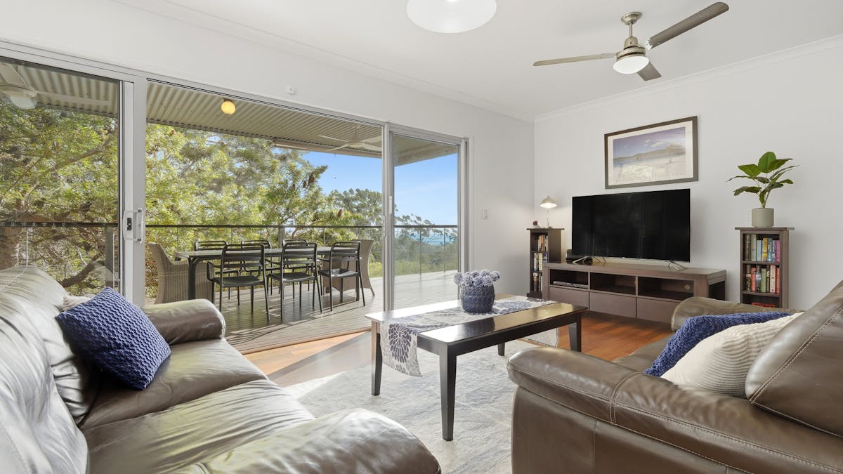 Light-filled upstairs lounge opens directly onto the outdoor deck and views creating a relaxed space