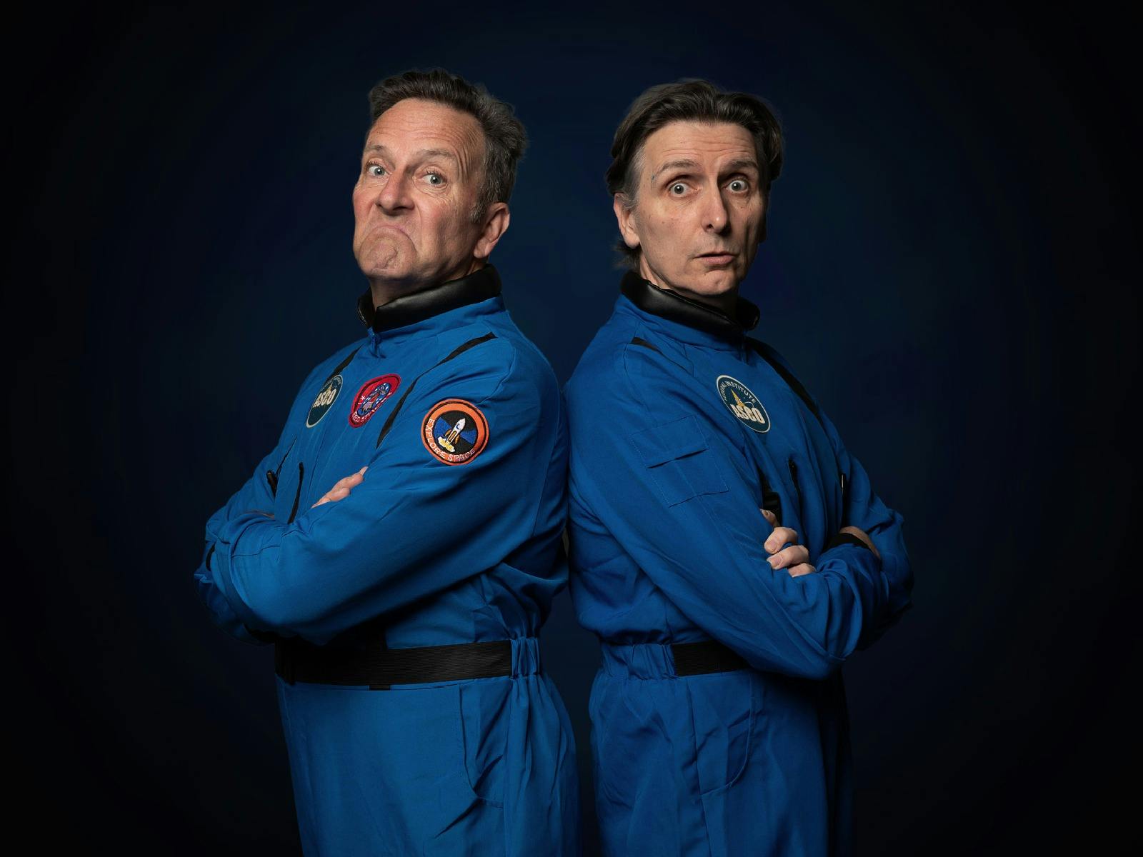 Comedians Colin Lane and Frank Woodley standing back to back dressed as astronauts