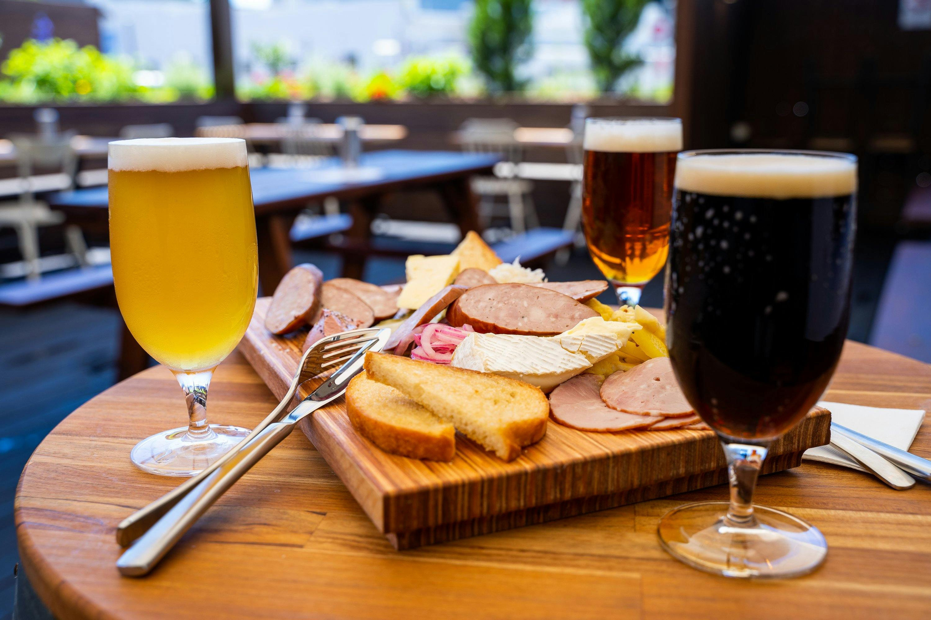 Brewers board with three kinds of beer on the barrel