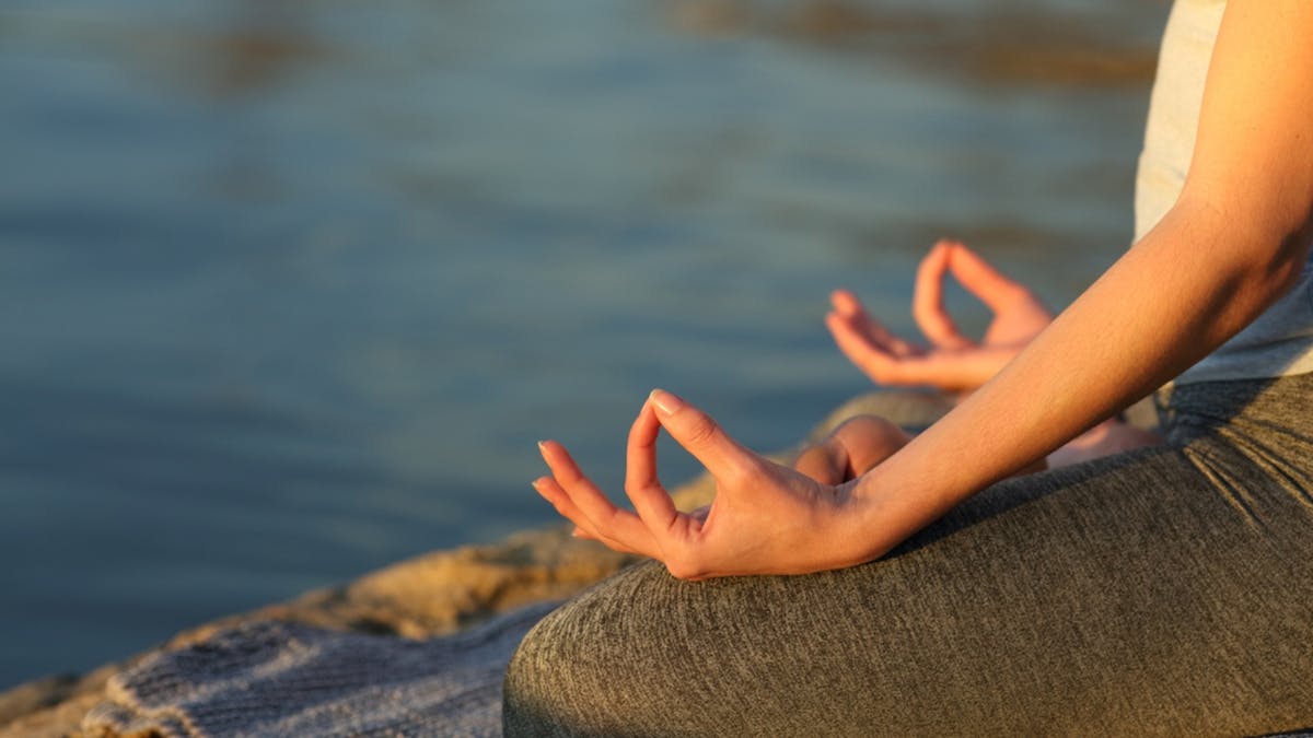 Lady doing yoga by the lake Lady doing yoga by the lake