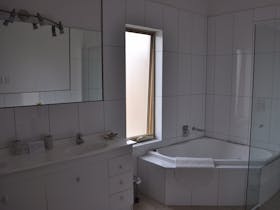 The main bathroom features a spa bath.
