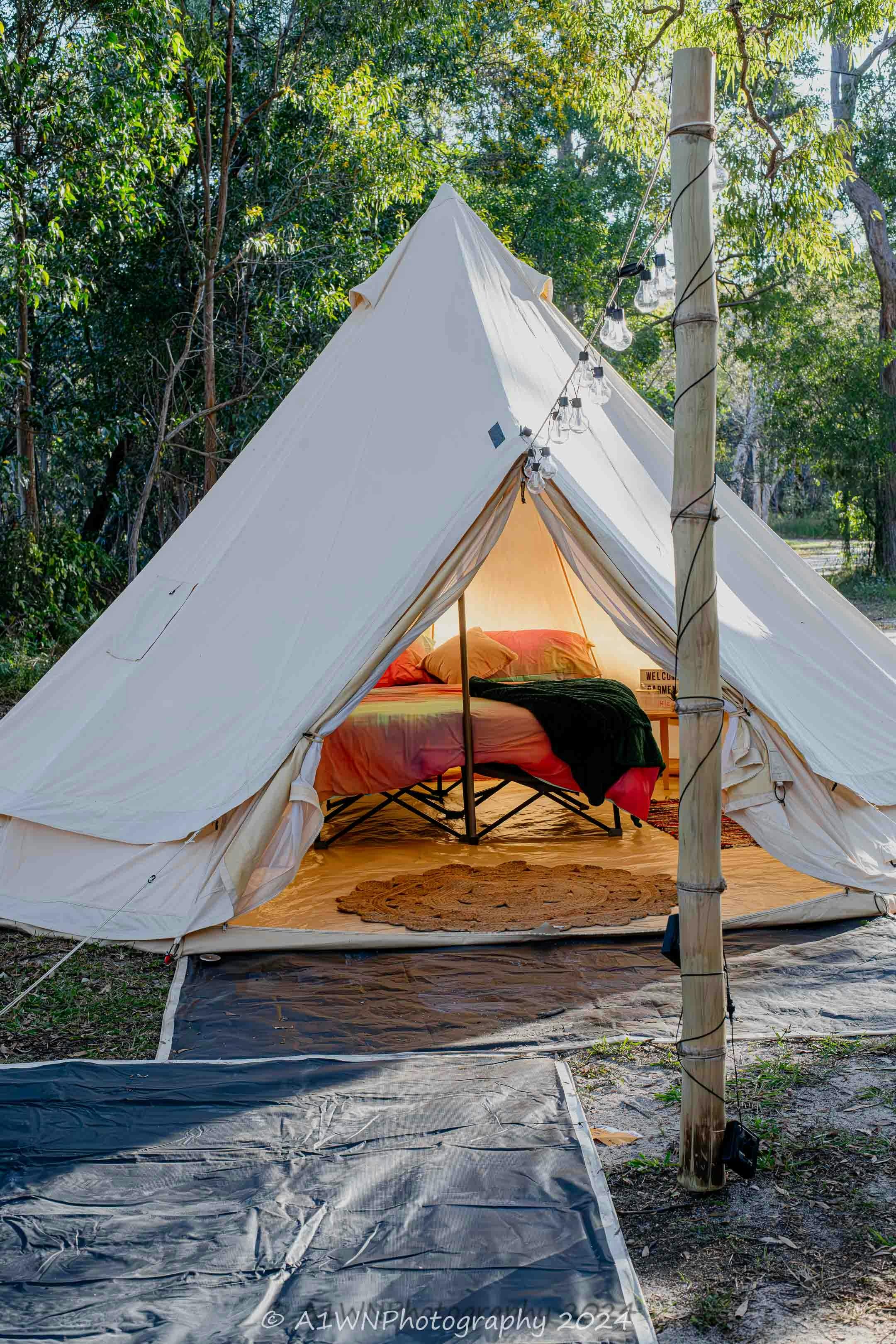 Bell Tent showing a comfortable double bed on a stretcher