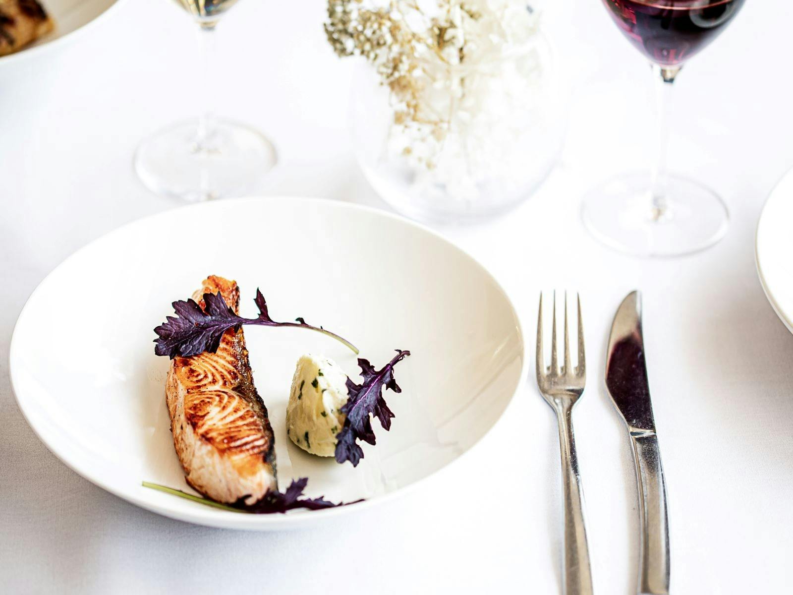 Plated Salmon on white linen table