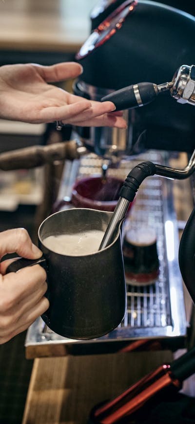 Trader & Co Barista serving award-winning, in-house roasted specialty Six8 Coffee.