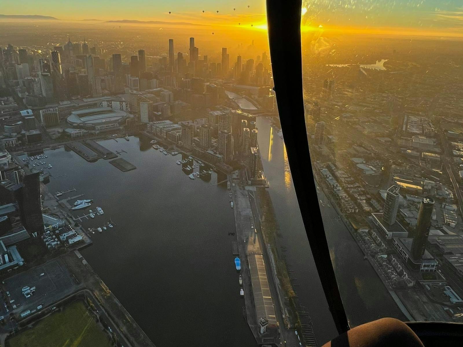 Sunrise view of Melbourne CBD from the helicopter cockpit