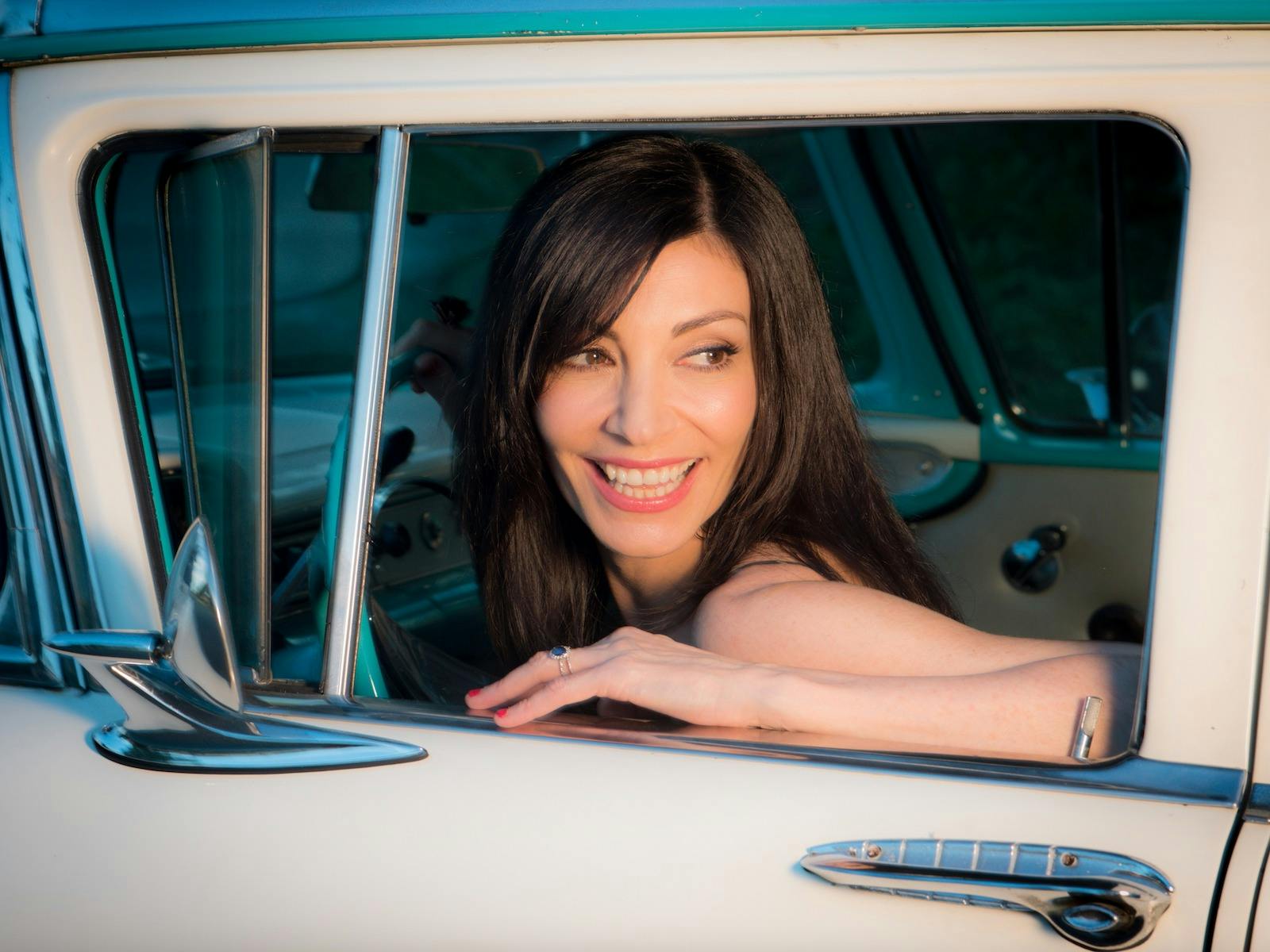 colour photo of Danielle De Andrea sitting in a car looking out the window
