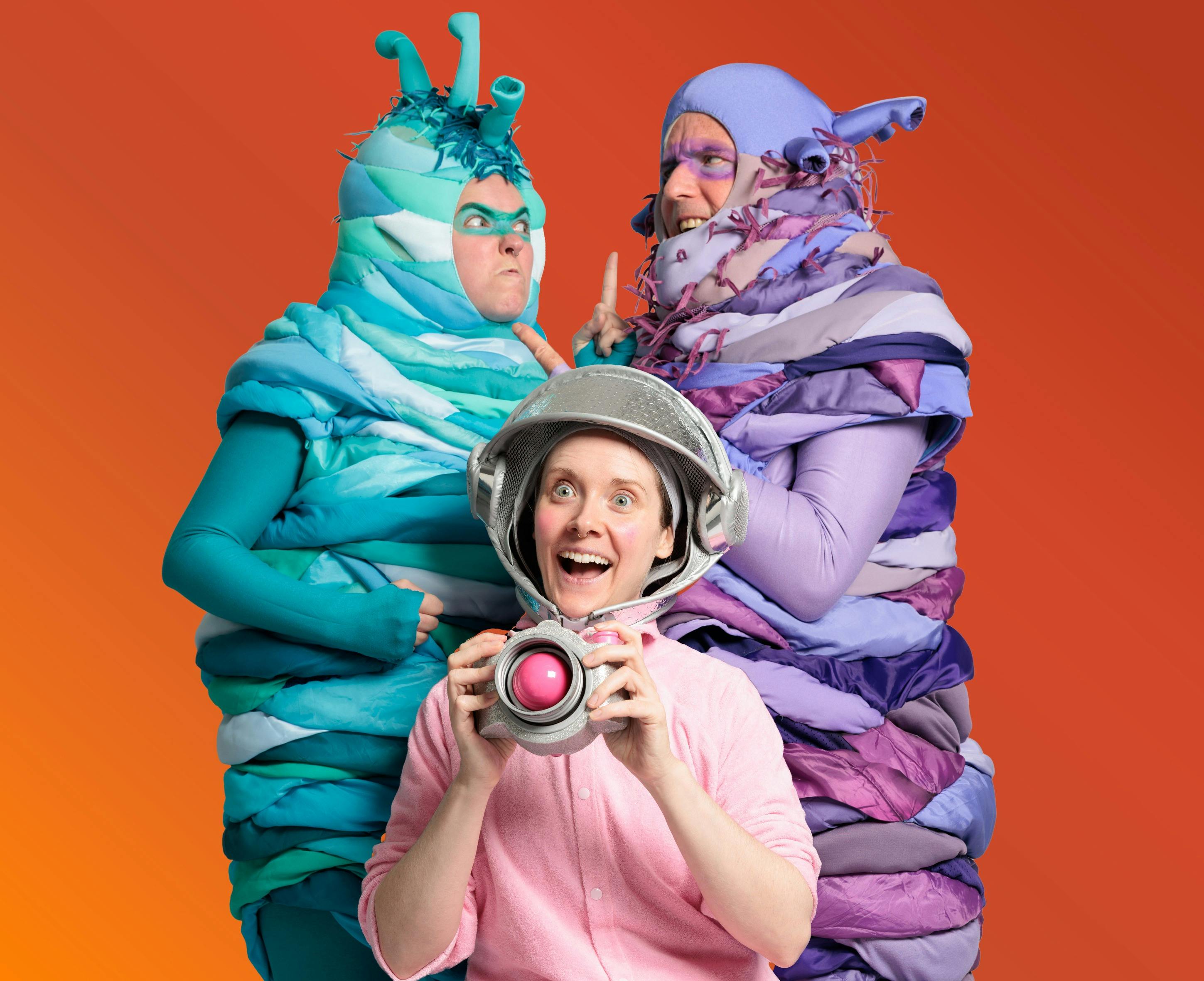 Two aliens fight behind a human baby on an orange background