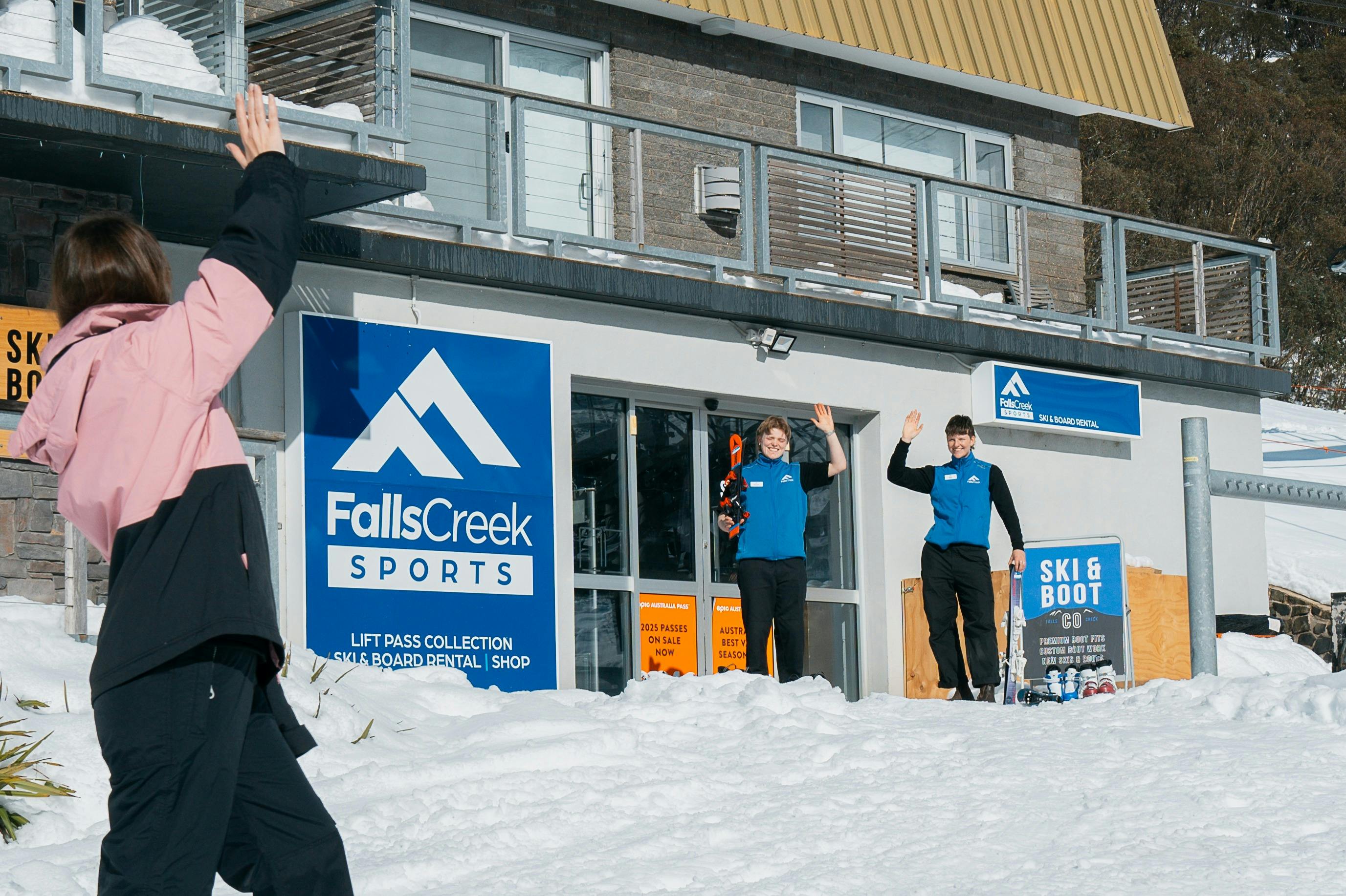 Staff waving from store front